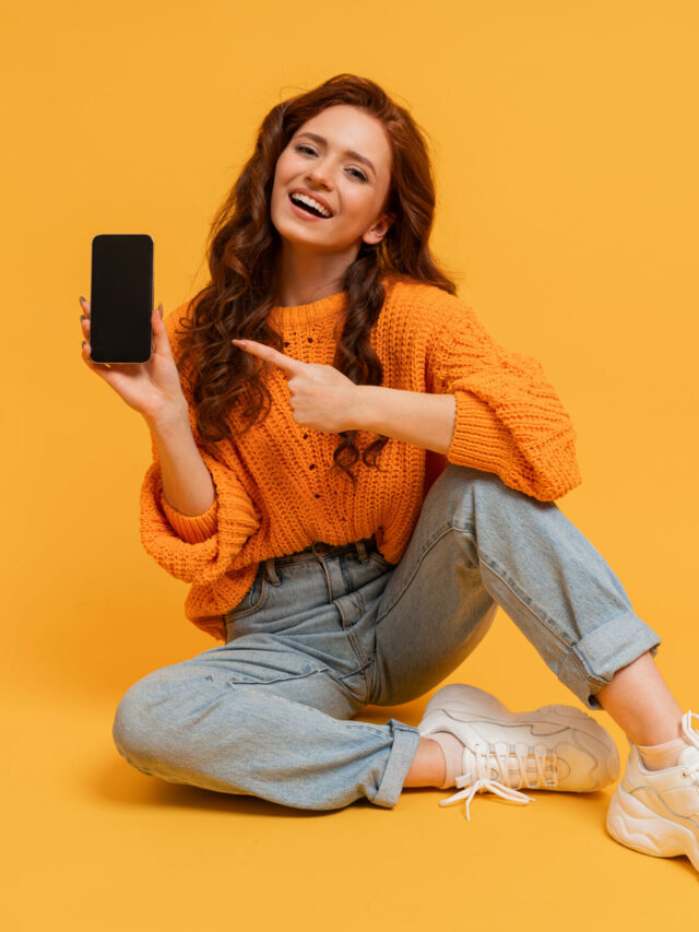 cropped-happy-millennial-woman-showing-smartphone-screen-pointing-it-scaled-1.jpg