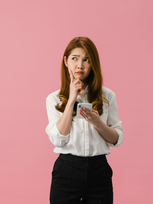 cropped-thinking-dreaming-young-asia-lady-using-phone-with-positive-expression-dressed-casual-clothing-feeling-happiness-stand-isolated-pink-background-scaled-2.jpg